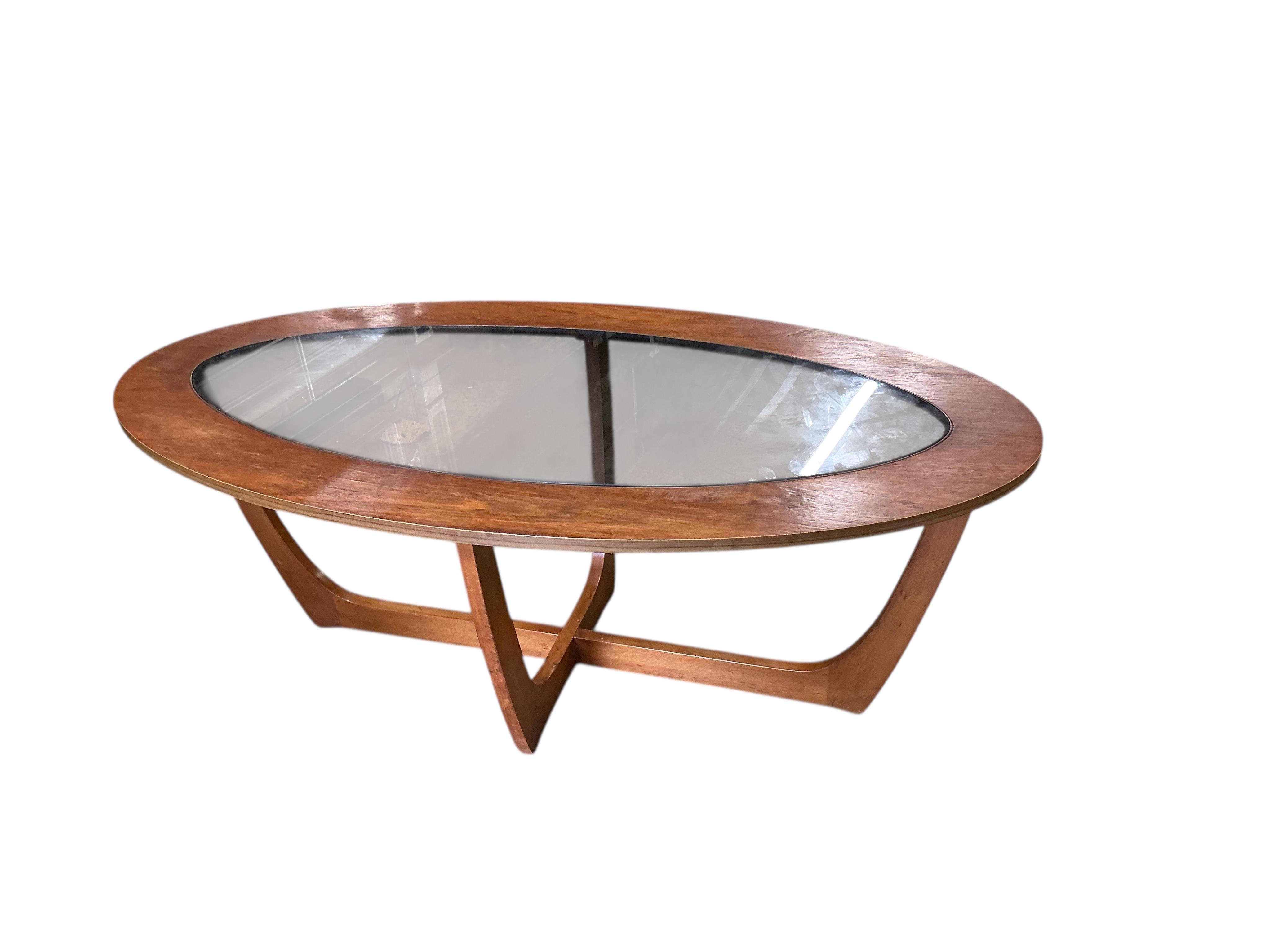 A mid century teak oval glass top coffee table, width 106cm, depth 53cm, height 41cm